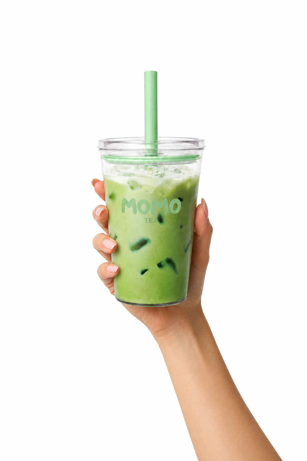 A hand holding a clear plastic cup of green iced tea with a light green straw and lid, against a solid white background.