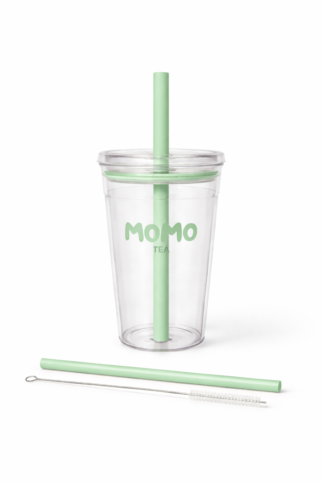 A clear plastic tumbler cup with a light green lid and matching straw, featuring the green text 'MOMO TEA' on the front. A second light green straw and a metal cleaning brush are placed below the cup on a clean white background.